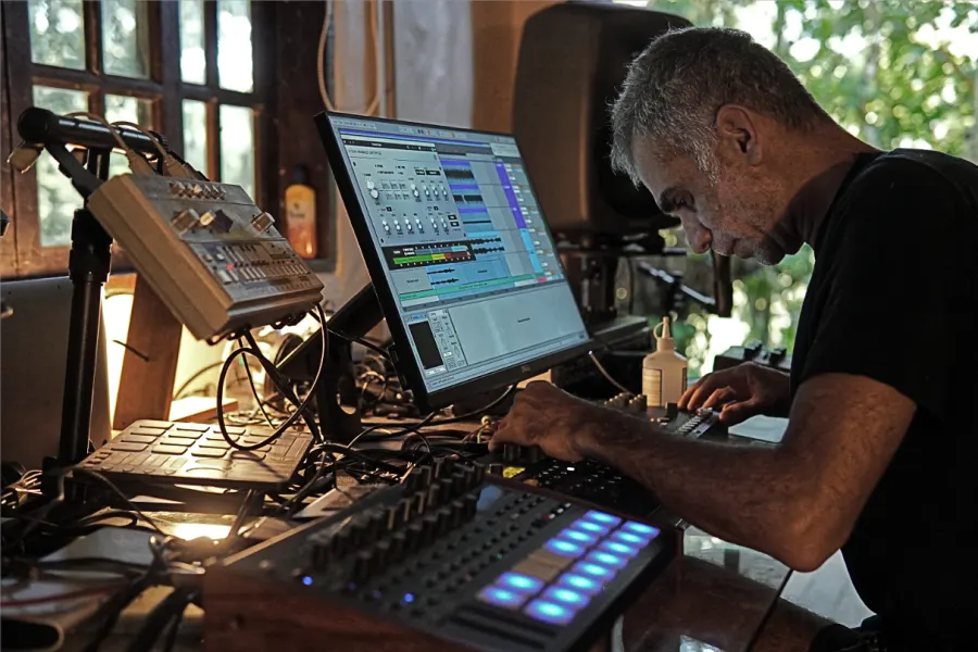 Dosel studio session with workstation, audio gear and forest view